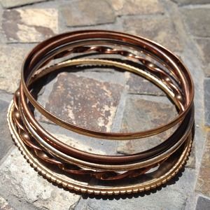 Six gold color bracelets . Six gold color bracelets .