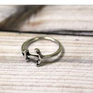 Silver anchor midi rings above the knuckle rings Silver anchor midi rings above the knuckle rings