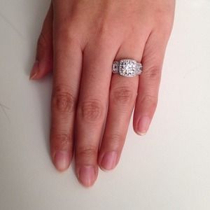 Sterling silver three stone halo engagement ring Sterling silver three stone halo engagement ring