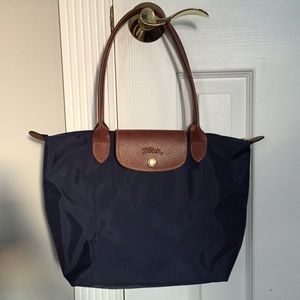 Longchamp Handbags - Brand NEW, authentic Longchamp Le Pliage in Navy. Longchamp Handbags - Brand NEW, authentic Longchamp Le Pliage in Navy.