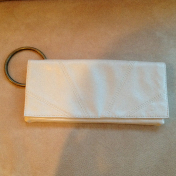 Off white clutch with large brass handle. New!