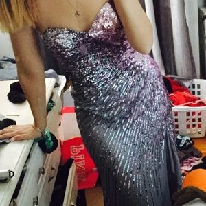 A tight black dress with one pink shoulder strap.