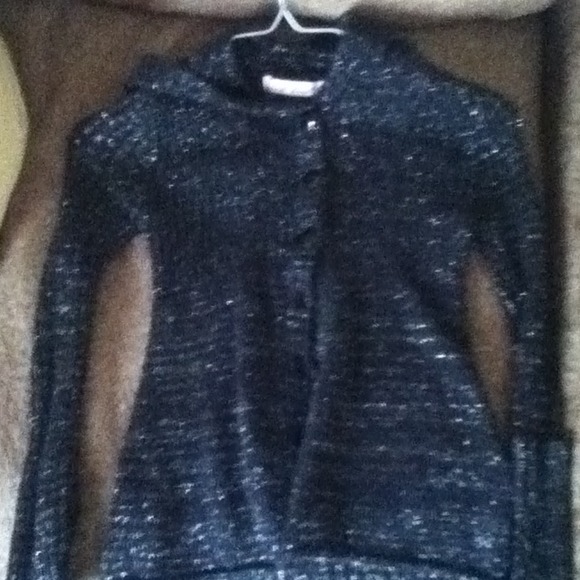 A sparkly, black long sleeved button up sweater