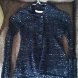 A sparkly, black long sleeved button up sweater