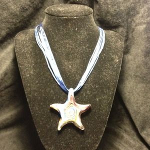 Glass starfish pendant on a blue ribbon necklace