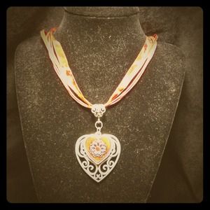 Heart shaped pendant on red ribbon necklace