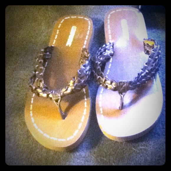 Brown Wurl sandals w/ a whitish yellow print.