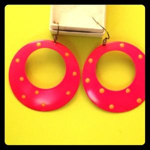 Pink hoop earrings with orange polka dots