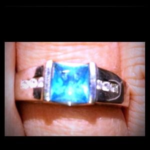 White gold, blue topaz, 6 diamonds, size 8.