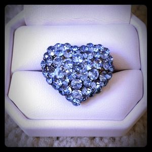 Sparkly blue heart-shaped ring.