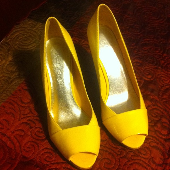 Yellow ALDO open toe heels.