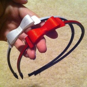 White bow headband along with red headband.