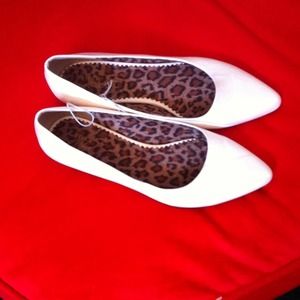 White leather pointed toed flats.