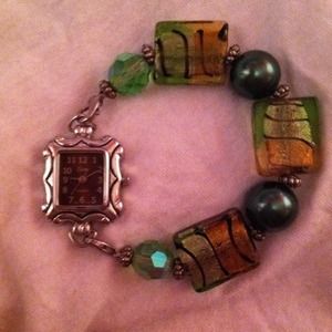 watch with green embellishment s