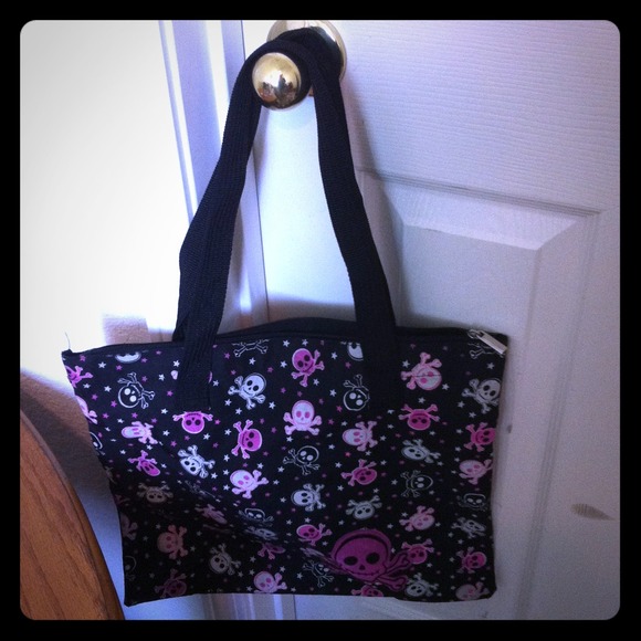 Black bag with a pink and white skull pattern