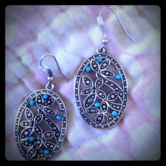 Silver earrings with blue stones.