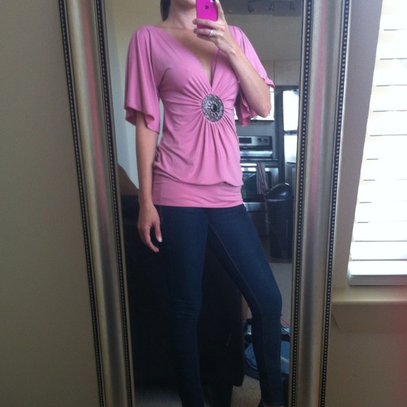 Pink polyester shirt with broach in the center. - Picture 1 of 3
