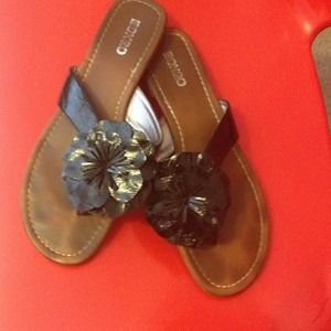 Black sandal with flower.