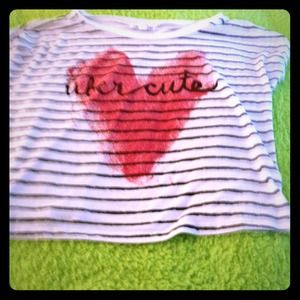 A short sleeve shirt with stripes and a design