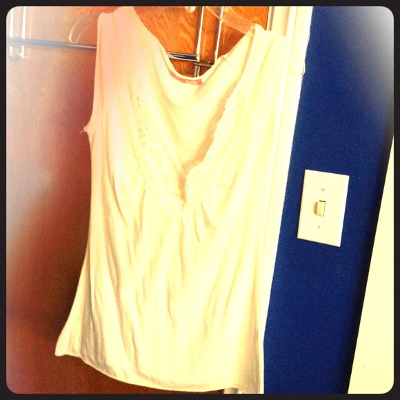 Cream colored shirt, deep "V" with sequins.