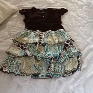 Girls dress-brown top, and tiered patterned skirt.