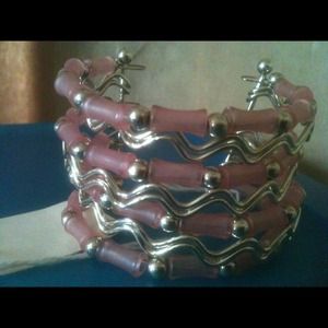 Cute silvertone and pink cuff style bracelet.