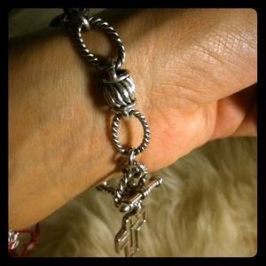 Silver toned bracelet with a cross
