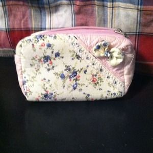A  pink and white clutch with diamonds and flowers