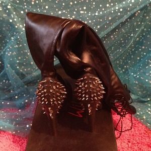 Black thigh-high spiked boots.