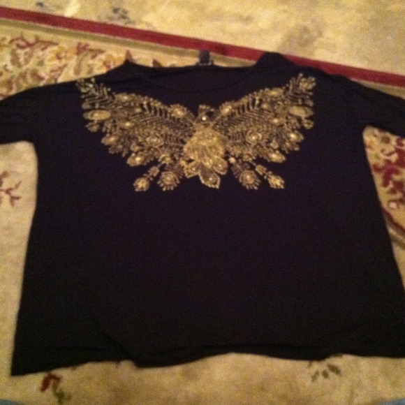 Black shirt with gold peacock on the front