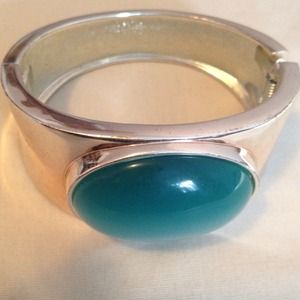 Silver bangle with blue stone