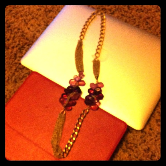 Gold necklace with purple and pink stone detail