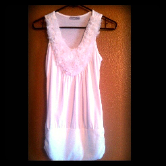 A sleeveless top with white fluffy roses
