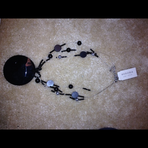Black disc necklace.