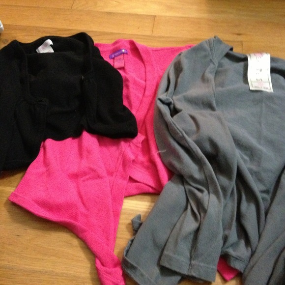 Three girls shrugs.