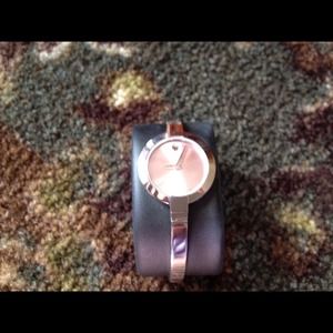 Movado watch with pink face.