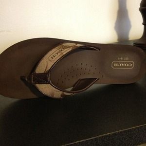 Brown and tan Coach flip flops