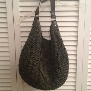 Green woven purse w/ brown strap.