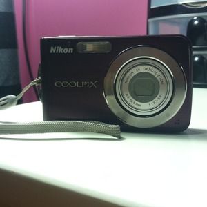 Nikon digital camera and 2 iPhone 5 cases