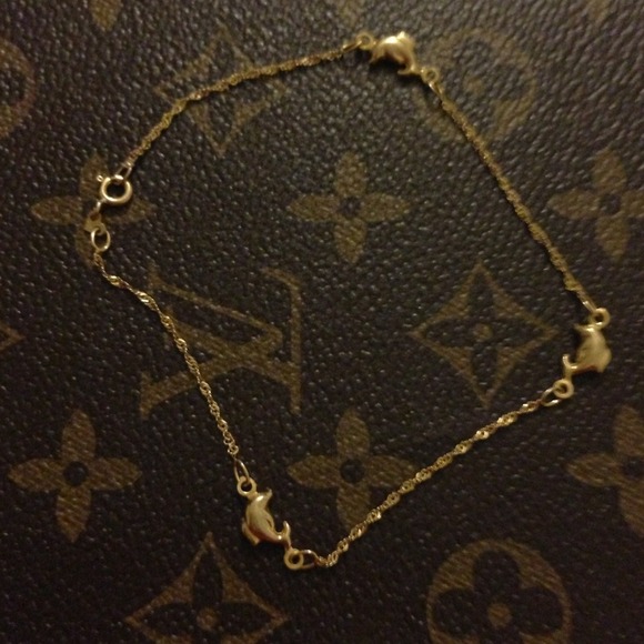 14K yellow gold anklet (dolphins).