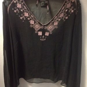 Sheer black top with pink design