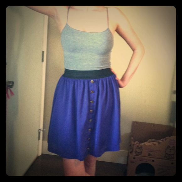 Purple skirt with gold button detail.