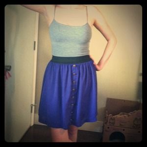 Purple skirt with gold button detail.