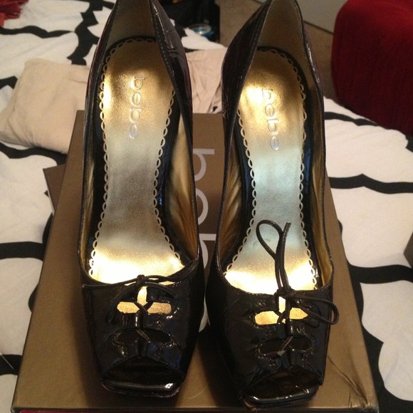 Bebe dark brown patent pep toe pump.