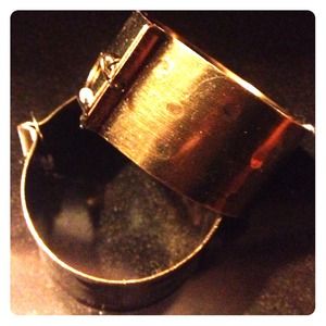 Large gold metal earrings with a light hammer look