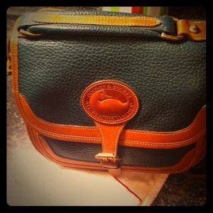 Dark green authentic dooney & bourke purse.