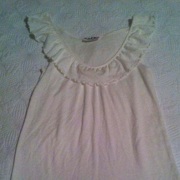 Sparkly sleeveless tunic with ruffle collar.
