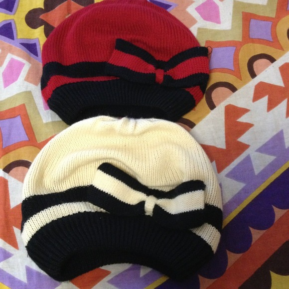 Red and off white beanies with navy blue outline.