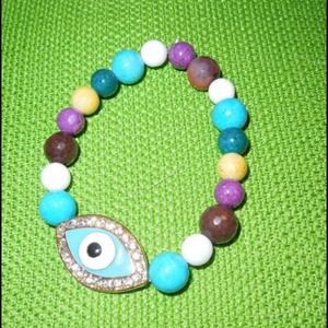 Gold stretch evil eye charm with glass beads