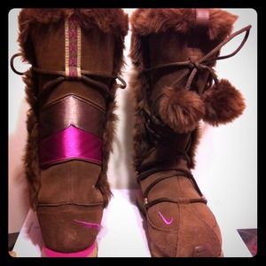 Brown and pink Nike boots